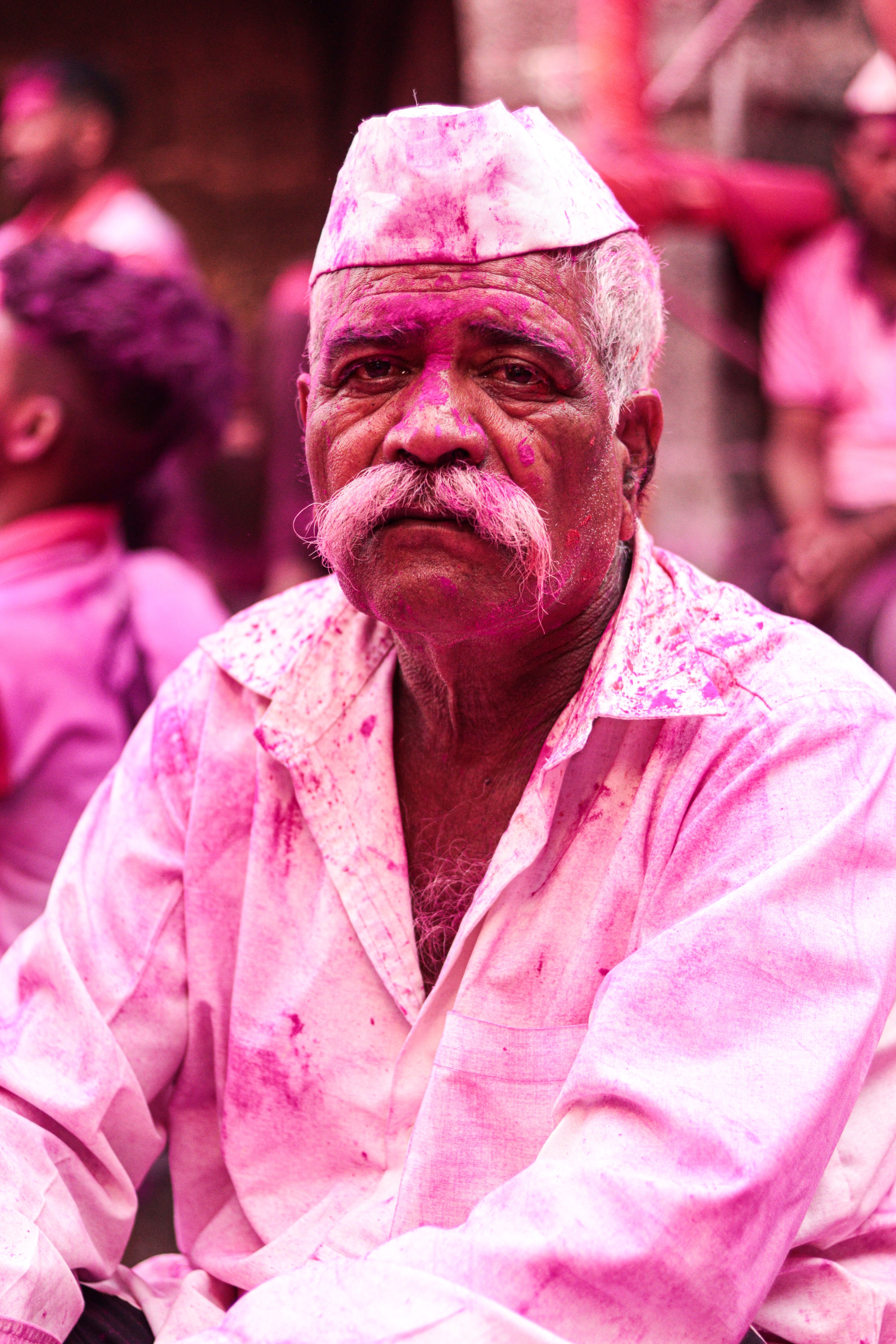 Portrait of a man celebrating amid bright pink powder